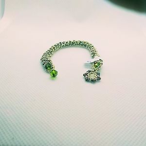 Silver and green hand woven bracelet.